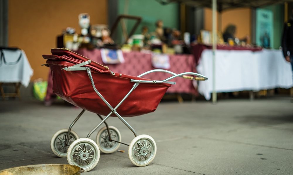 An empty baby stroller. Photo courtesy of Tommaso Pecchioli on Unsplash.