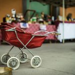 An empty baby stroller. Photo courtesy of Tommaso Pecchioli on Unsplash.
