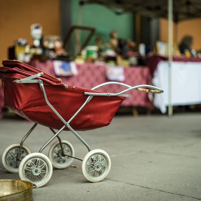 An empty baby stroller. Photo courtesy of Tommaso Pecchioli on Unsplash.