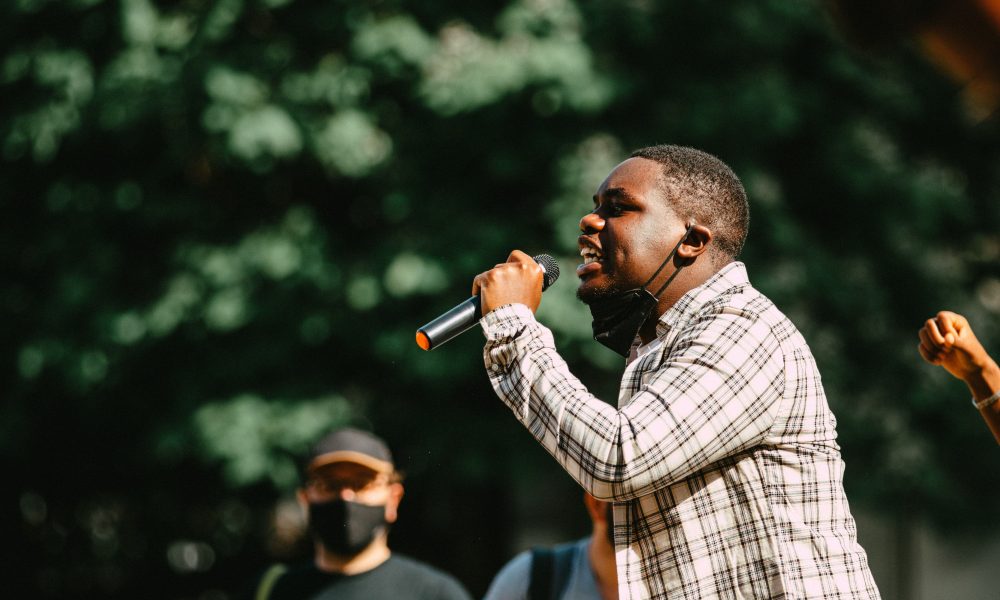 Black Lives Matter activist speaks to a crowd. Photo courtesy of Edward Howell on Unsplash.
