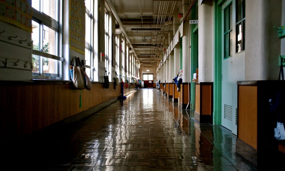 Image of an empty school hallway. Photo courtesy of Kyo Azuma on Unsplash