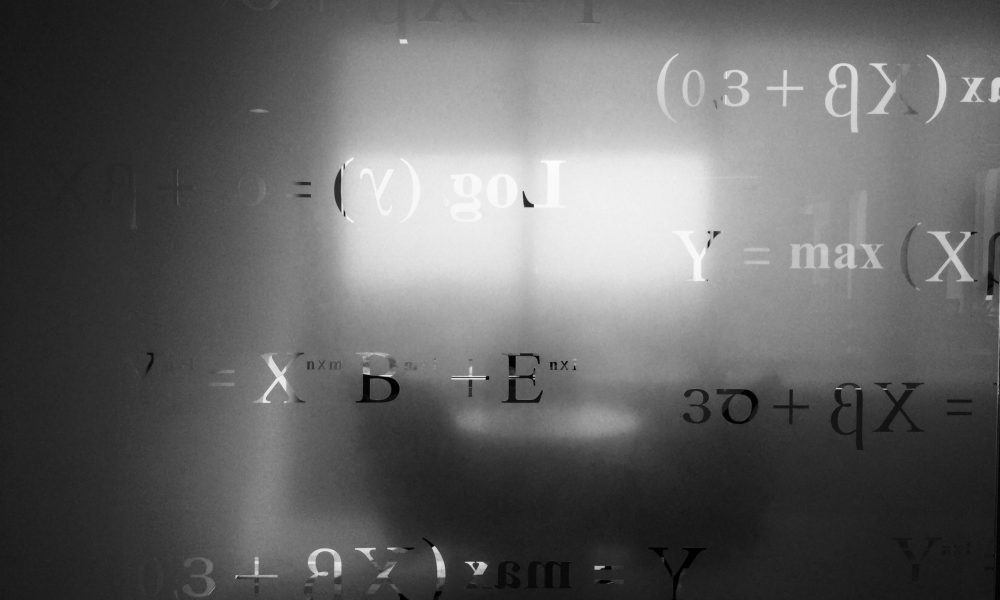 Image of frosted glass with math equations. Photo courtesy of Saad Ahmad
