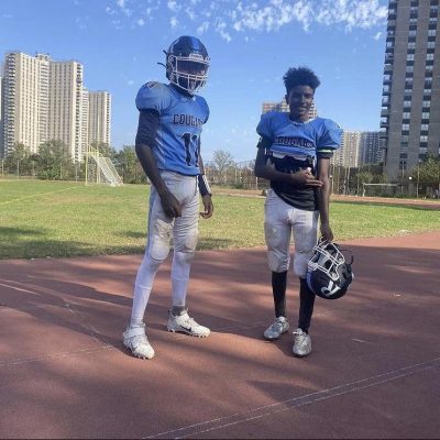 The author Jacob Tucker in his football uniform next to a teammate