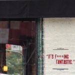 Writing on a cement wall that reads "it's f***ing fantastic"