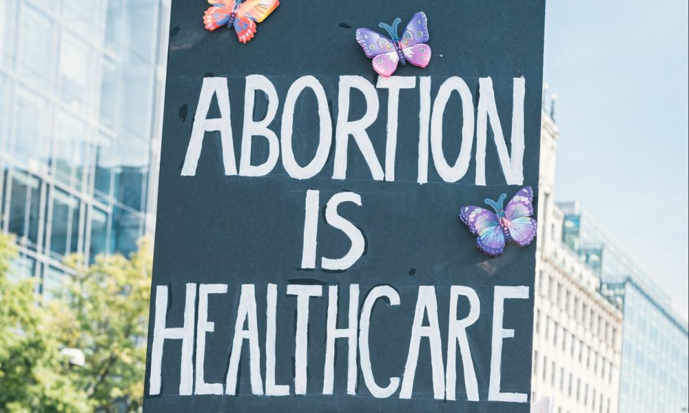 Women holding up a poster that reads "Abortion is healthcare"