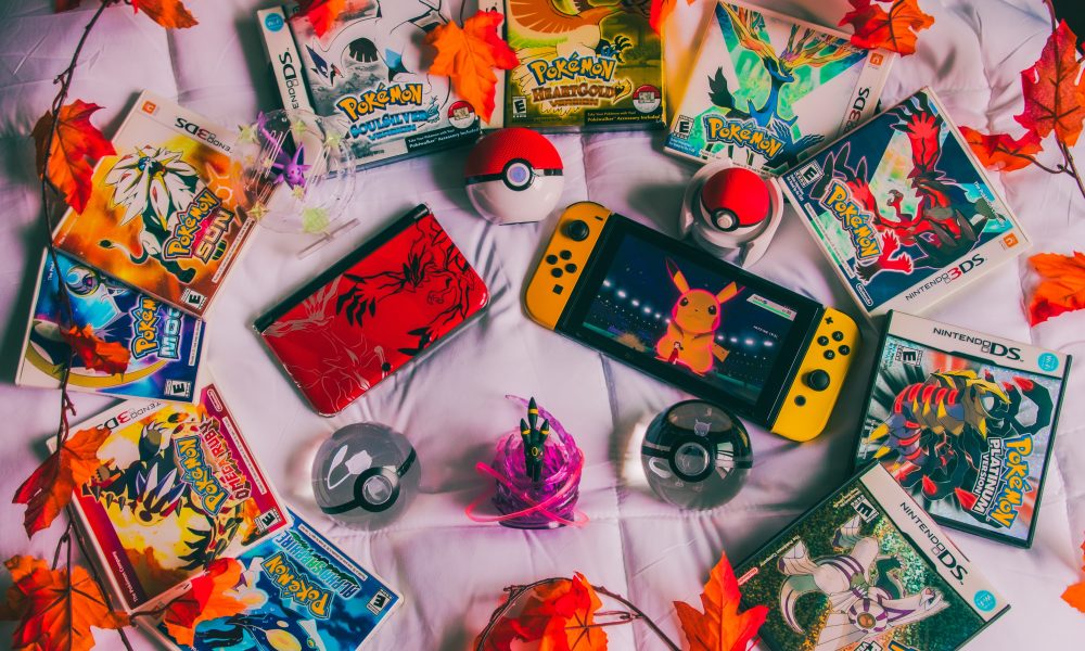 Photo of Pokemon cards and a nintendo switch. Photo courtesy of Branden Skeli on Unsplash.