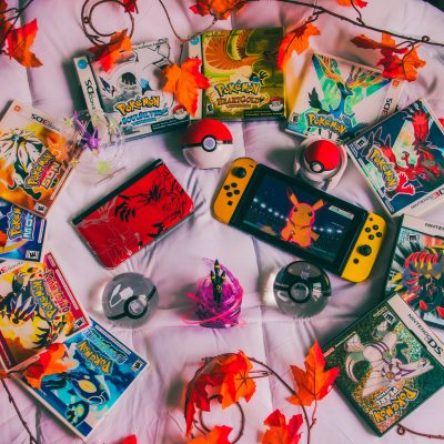 Photo of Pokemon cards and a nintendo switch. Photo courtesy of Branden Skeli on Unsplash.
