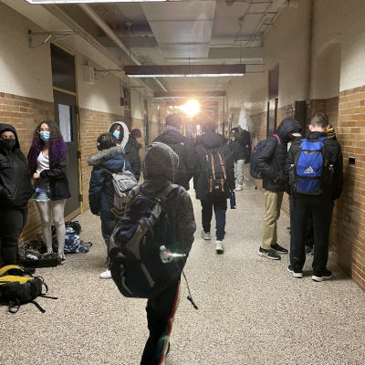 photo of student walking in a crowded hallway.