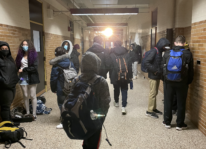 photo of student walking in a crowded hallway.