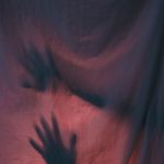 image of hands behind curtain scary