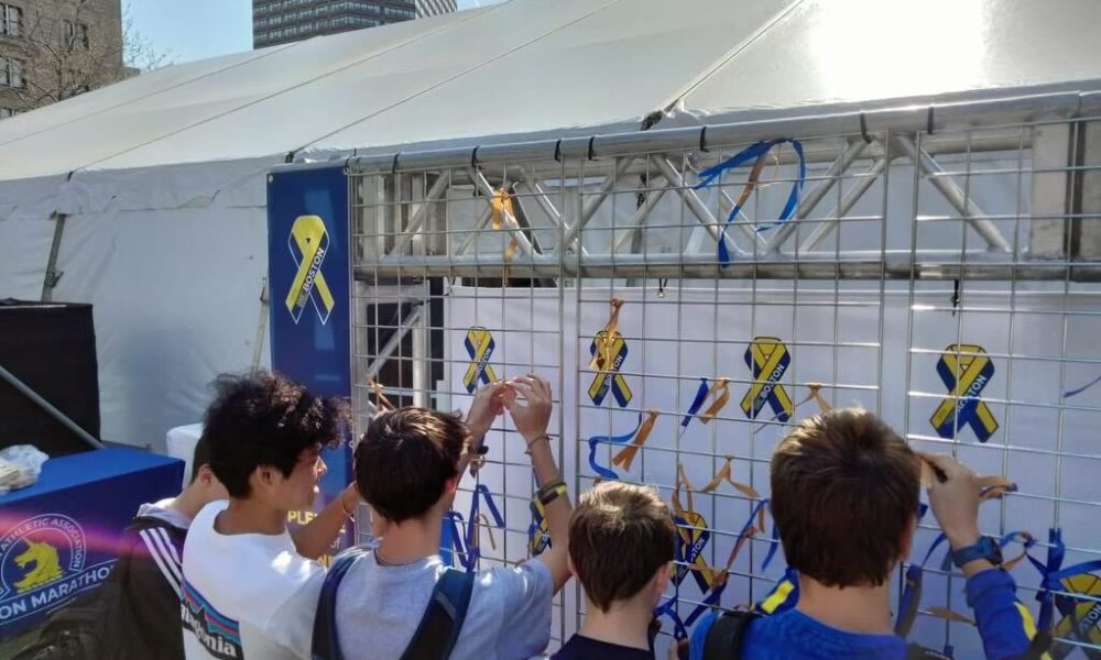 Youth pinning Boston Strong stickers