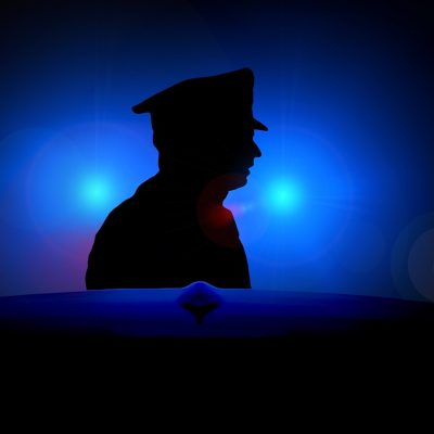 Blue Light Sirens. Police Officer in Headlights