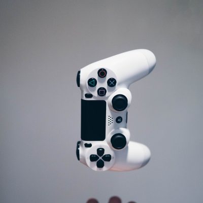 White Sony controller falling into someones hands. Photo courtesy of Nikita Kachanovsky on Unsplash.