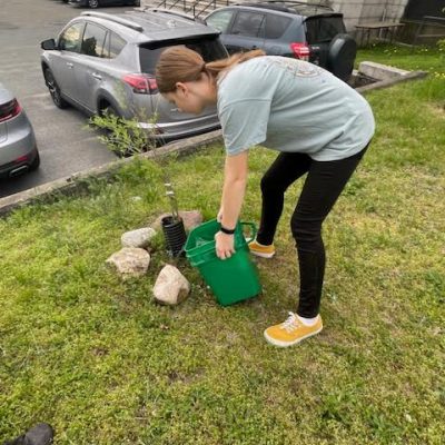 Photo of student cleaning up trash