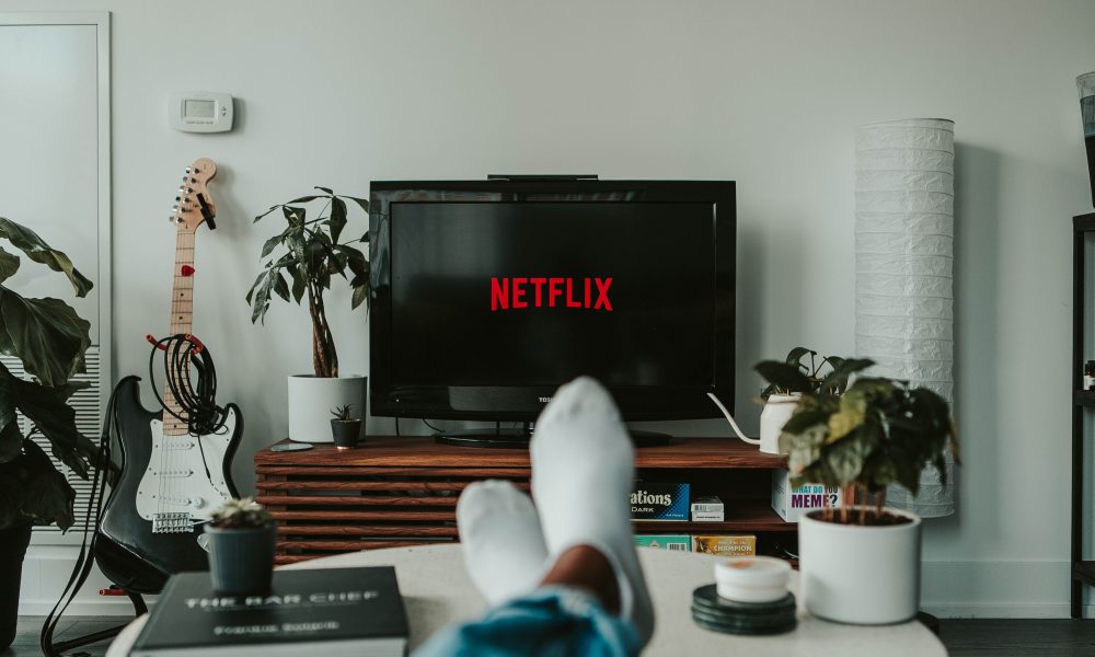Image of person relaxing in front of Netflix screen