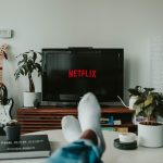 Image of person relaxing in front of Netflix screen