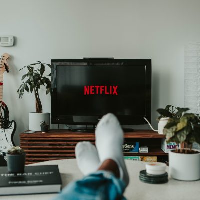 Image of person relaxing in front of Netflix screen