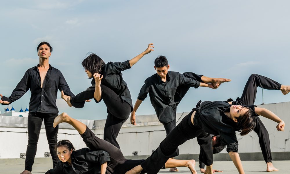Image of dancers posing in all black
