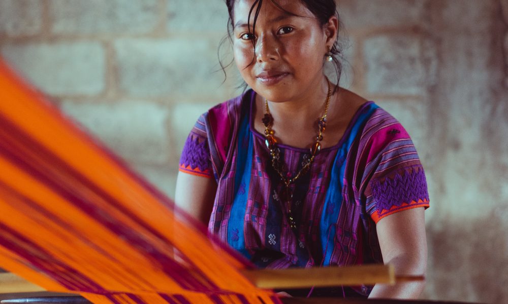 Woman working with fabric. Photo courtesy of Photo by Los Muertos on Pexels.