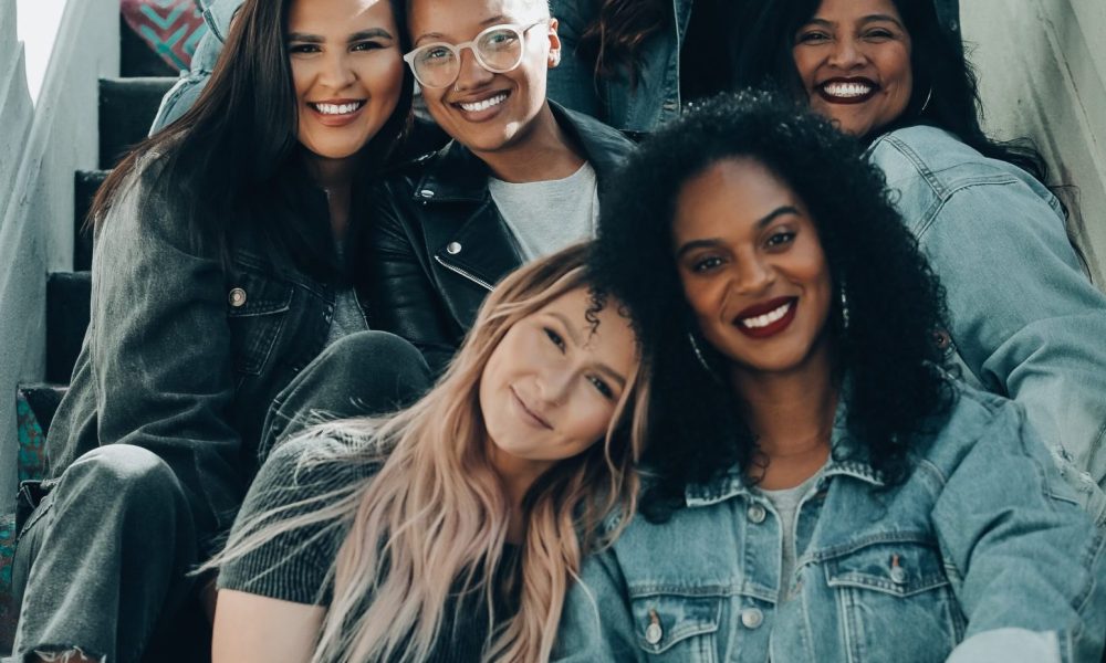 Photo of women sitting on steps. Photo courtesy of Joel Muniz on Unsplash.