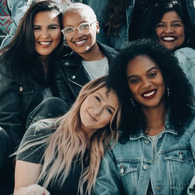 Photo of women sitting on steps. Photo courtesy of Joel Muniz on Unsplash.