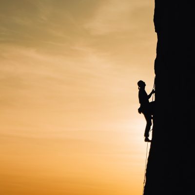 Person climbing a mountain. Photo by Анна Рыжкова on Unsplash.