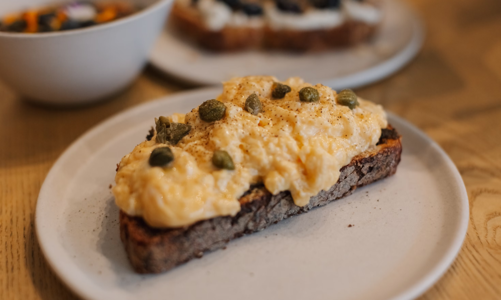 Scrambed eggs on toast with capers. Image courtesy of Janesca on Unsplash