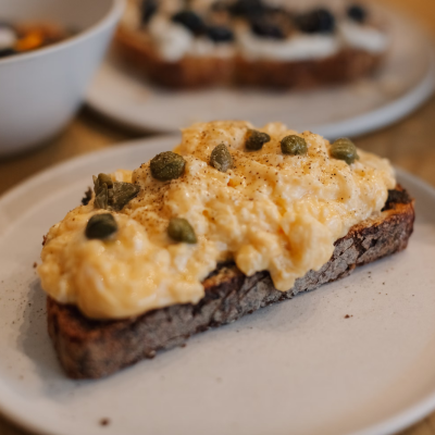 Scrambed eggs on toast with capers. Image courtesy of Janesca on Unsplash