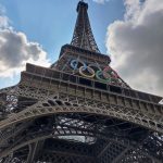 Photo of the Eiffel Tower with the Olympic logo on it. Photo courtesy of Amada MA on Unsplash.