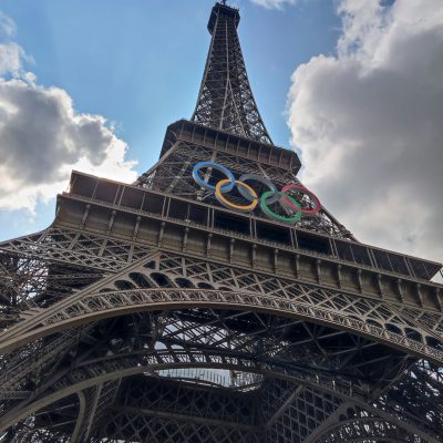 Photo of the Eiffel Tower with the Olympic logo on it. Photo courtesy of Amada MA on Unsplash.