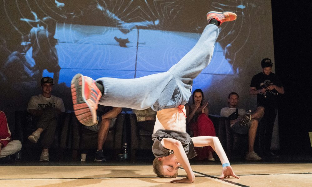 Photo of a breakdancer performing a dance move. Photo courtesy of Ilja Tuli on Unsplash.