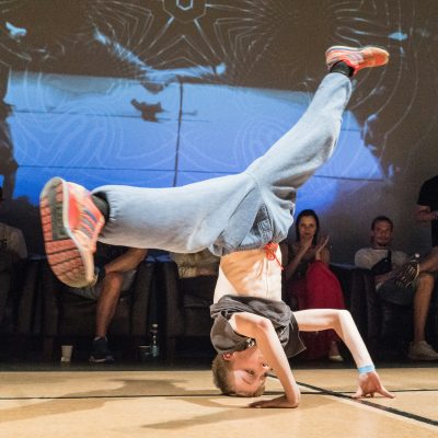 Photo of a breakdancer performing a dance move. Photo courtesy of Ilja Tuli on Unsplash.