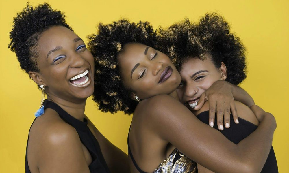 Women Wearing Party Dresses Hugging Each Other. Photo courtesy of Nappy on Pexels.