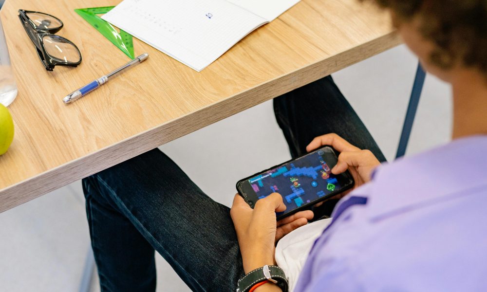 Boy in Purple Shirt Playing on Mobile Phone Photo by Yan Krukau on Pexels.