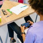 Boy in Purple Shirt Playing on Mobile Phone Photo by Yan Krukau on Pexels.