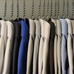Assorted color dress shirts on clothes hangers. Photo courtesy of Waldemar on Unsplash.