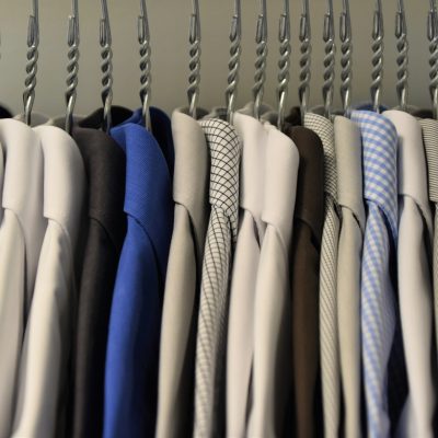 Assorted color dress shirts on clothes hangers. Photo courtesy of Waldemar on Unsplash.
