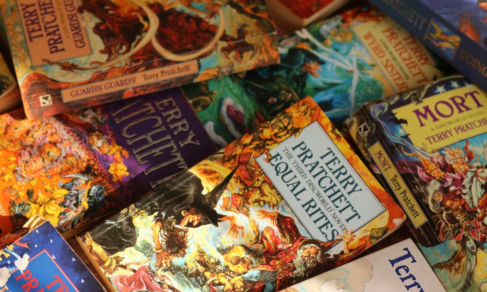 Stack of books. Photo courtesy of Alicia Christin Gerald on Unsplash.