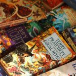 Stack of books. Photo courtesy of Alicia Christin Gerald on Unsplash.