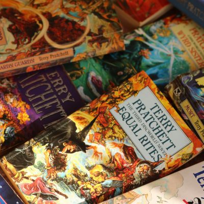 Stack of books. Photo courtesy of Alicia Christin Gerald on Unsplash.