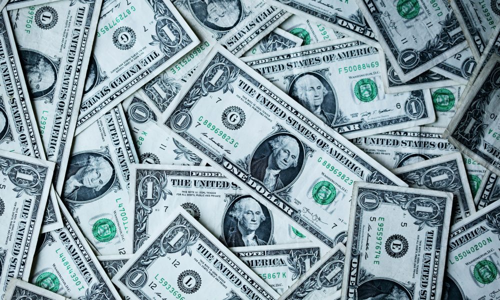 Picture of dollar bills courtesy of Alexander Grey on Unsplash.
