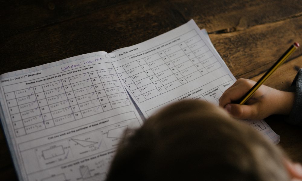 Student sitting at desk doing homework courtesy of Annie Spratt on Unsplash.
