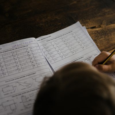 Student sitting at desk doing homework courtesy of Annie Spratt on Unsplash.