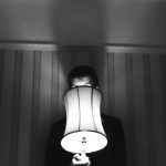 Photo of someone behind a lamp courtesy of henry perks on Unsplash.