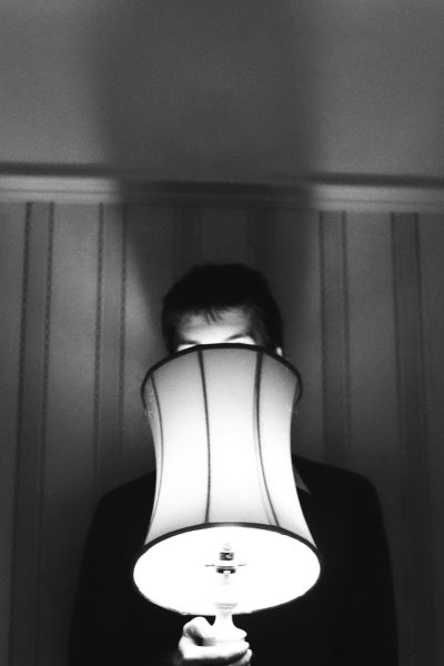 Photo of someone behind a lamp courtesy of henry perks on Unsplash.