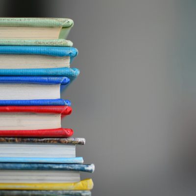 Photo of stack of books courtesy of Kimberly Farmer on Unsplash