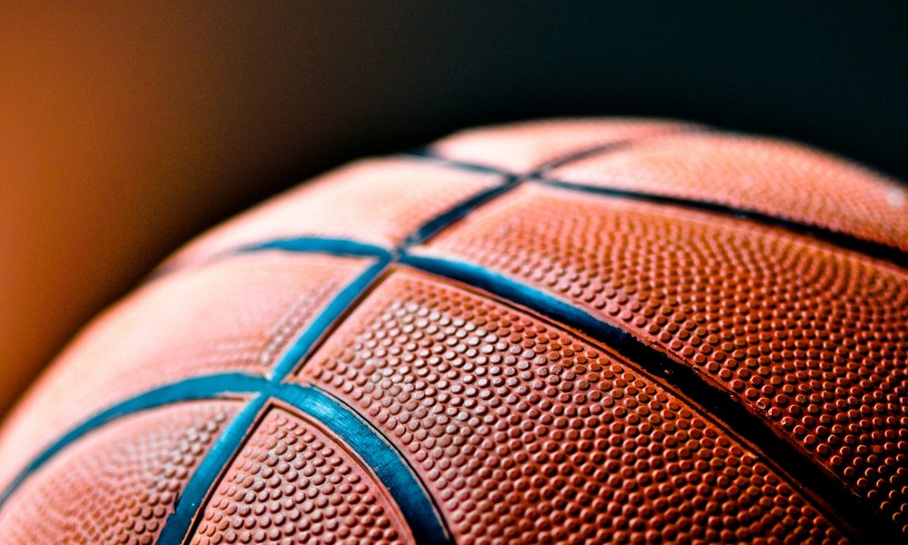 Photo of basketball courtesy of Kylie Osullivan on Unsplash.