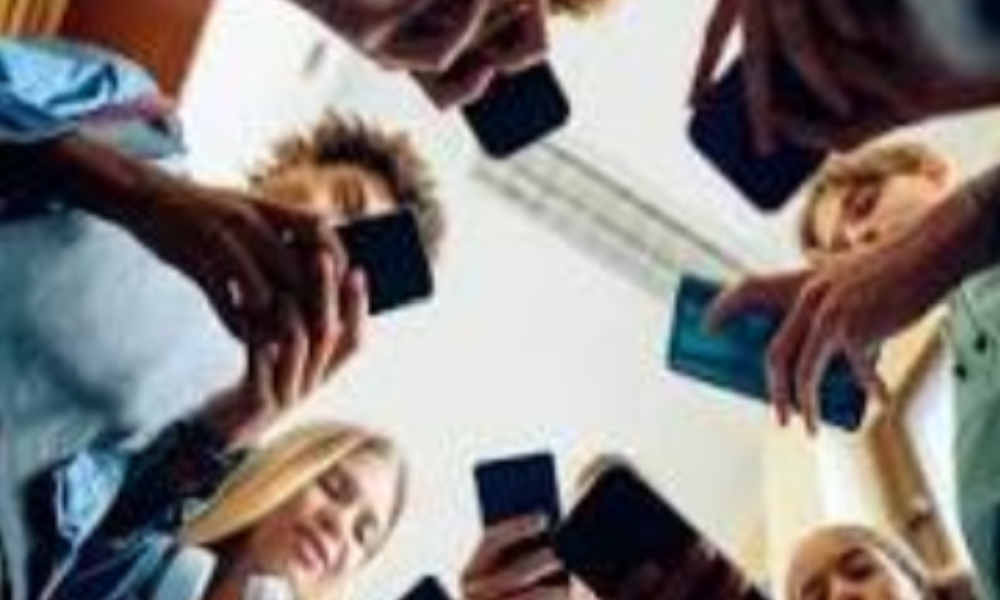 Photograph of teenagers using their phones