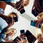 Photograph of teenagers using their phones