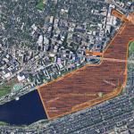 Arial photo of the Charles River, with spread of bacteria colored in orange.